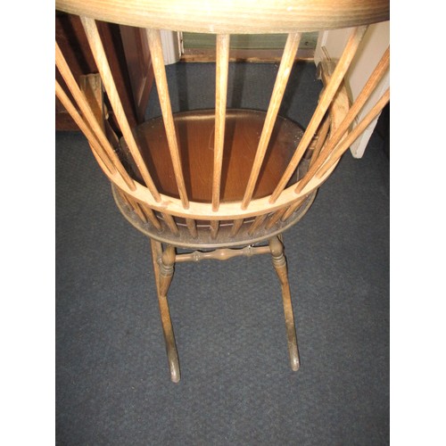 100 - A vintage stick back rocking chair, in well used condition with use-related marks