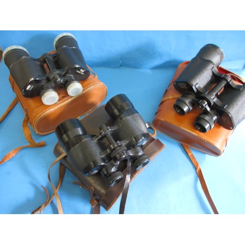 113 - 3 Pairs of binoculars, each in leather case and focus ok, all with use related marks