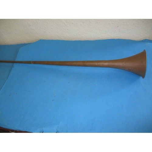 120 - A vintage copper hunting horn, of two part construction, in need of a clean, approx. length 125cm