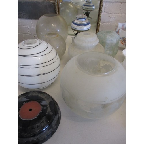 129 - A quantity of oil lamps and parts, to include antique shades, all in used condition