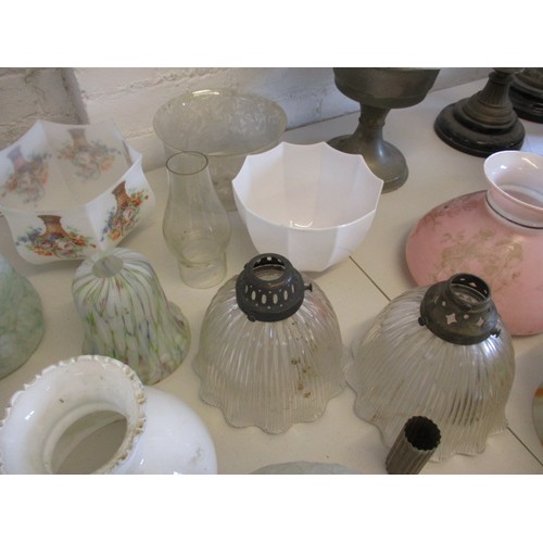 129 - A quantity of oil lamps and parts, to include antique shades, all in used condition