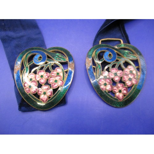 An art nouveau enamelled copper belt buckle with entwined snake bordering flowers, some enamel loss