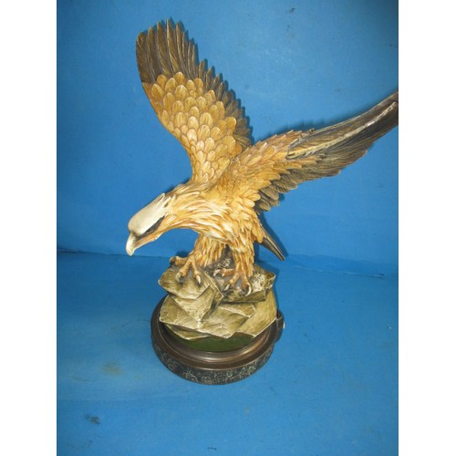 A vintage lamp body depicting an eagle in flight, having general use-related marks and requires wiring