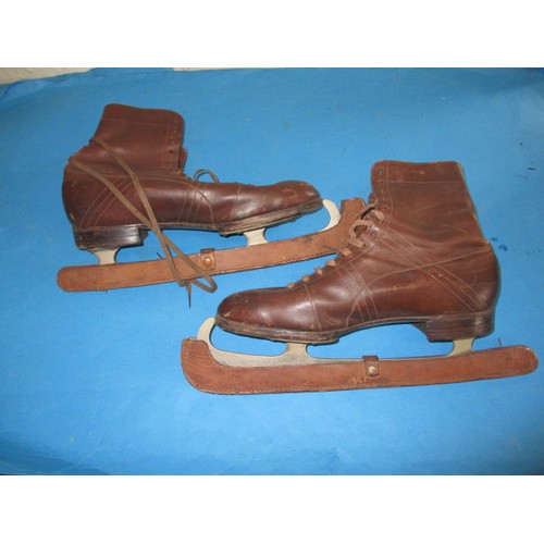 A pair of vintage Manfield ladies leather ice skates with original blade protectors, in good used condition