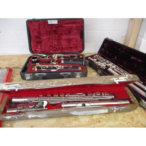 267 - Two flutes and a clarinet, in hard cases, in need of clean and possibly repairs