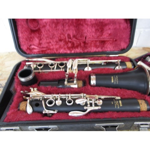 267 - Two flutes and a clarinet, in hard cases, in need of clean and possibly repairs