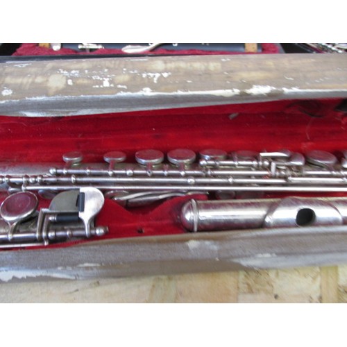 267 - Two flutes and a clarinet, in hard cases, in need of clean and possibly repairs