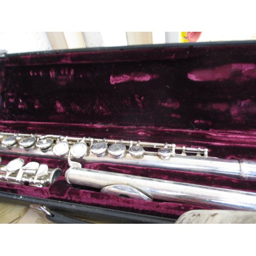 267 - Two flutes and a clarinet, in hard cases, in need of clean and possibly repairs