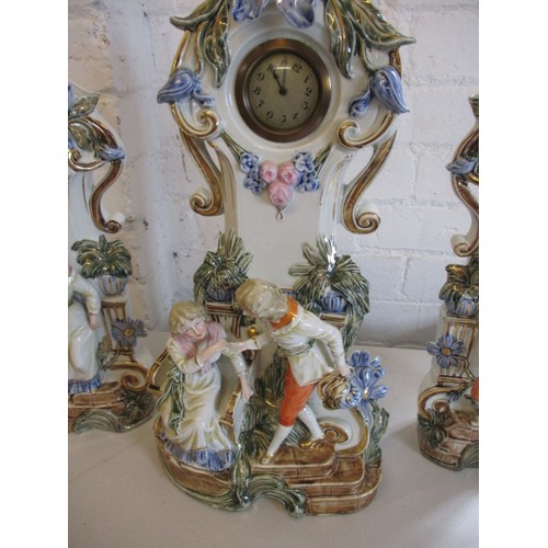 289 - A 19th century German porcelain mantle garniture of 2 vases and a clock stand. Clock not working. In... 