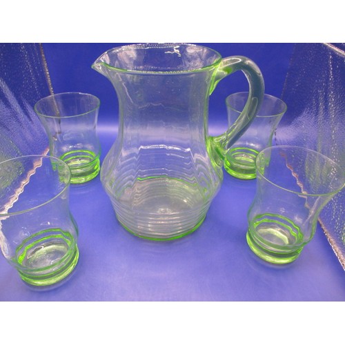 300 - A 1930s uranium glass lemonade set, 4 glasses and a jug, two glasses with small chips to edge