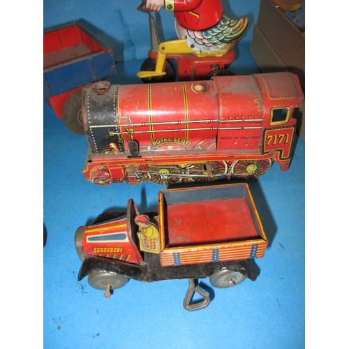 309 - A parcel of vintage tin-plate toys, some clockwork, all in used condition and not tested as to funct... 