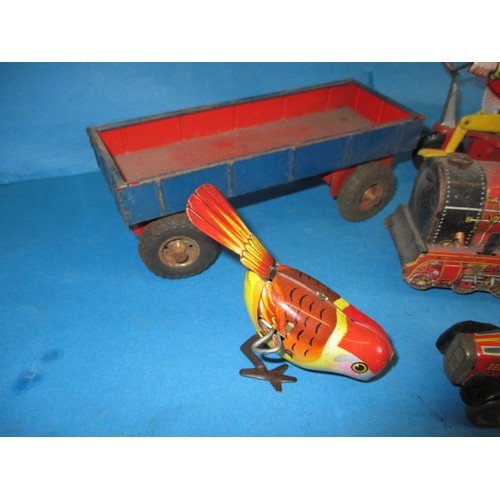 309 - A parcel of vintage tin-plate toys, some clockwork, all in used condition and not tested as to funct... 