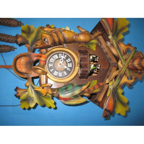 315 - A vintage West German cuckoo clock, with dancing figure carousel and bird, not tested as to function... 