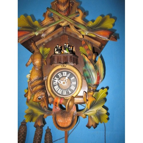 315 - A vintage West German cuckoo clock, with dancing figure carousel and bird, not tested as to function... 