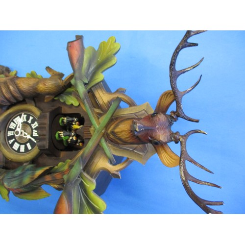 315 - A vintage West German cuckoo clock, with dancing figure carousel and bird, not tested as to function... 