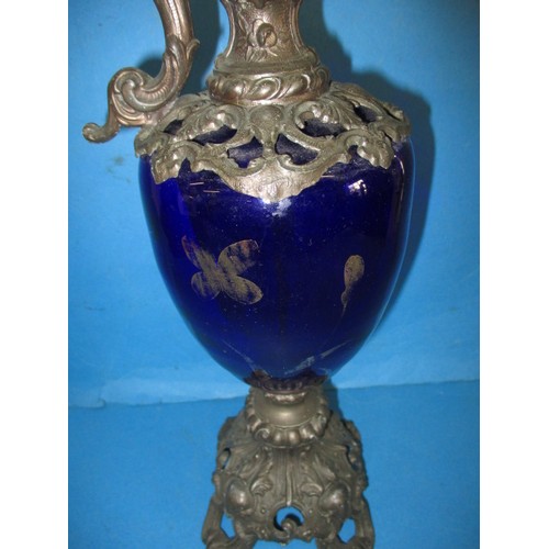 257 - A 19th century metal mounted blue glass ewer ornament, approx. height 49cm, having some loss to gilt... 