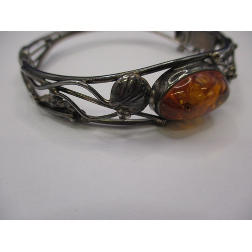 77 - A vintage silver bangle, having organic form with cabochon amber panel, in good pre-owned condition ... 