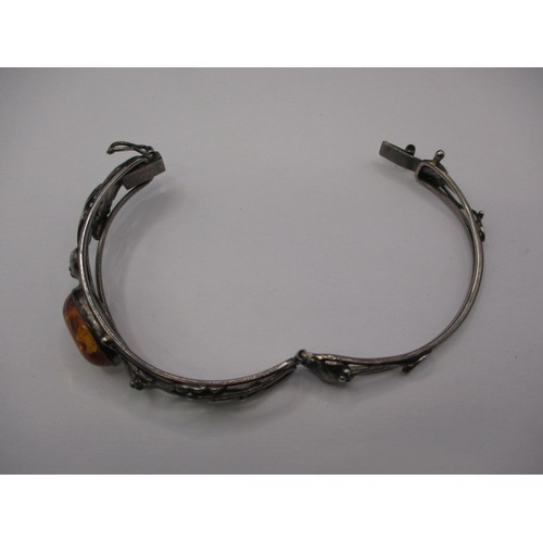 77 - A vintage silver bangle, having organic form with cabochon amber panel, in good pre-owned condition ... 