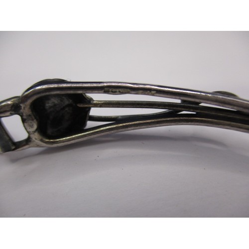 77 - A vintage silver bangle, having organic form with cabochon amber panel, in good pre-owned condition ... 