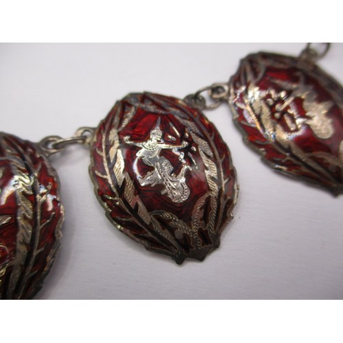 78 - A vintage Siam white metal necklace having 7 red niello panels, approx. linear length 43cm in used c... 