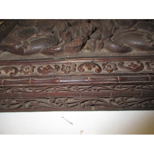 293 - A profusely carved antique Japanese hard wood box, approx. size 31x20x5cm in good used condition