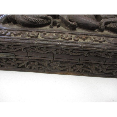 293 - A profusely carved antique Japanese hard wood box, approx. size 31x20x5cm in good used condition