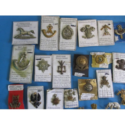 194 - A large quantity of metal military badges, all in good used condition, over 100 in total