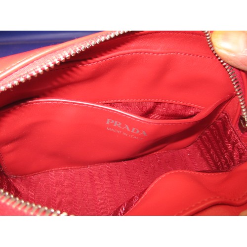 185 - A genuine PRADA chain shoulder crossbody bag, soft calf leather in colour ‘Rosso’, 1BH084. In unused... 