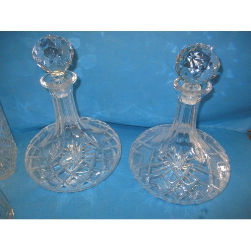 297 - A quantity of lead crystal and other drinks decanters, all in used condition, one carafe having a sm... 