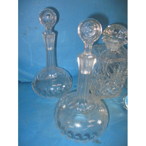 297 - A quantity of lead crystal and other drinks decanters, all in used condition, one carafe having a sm... 