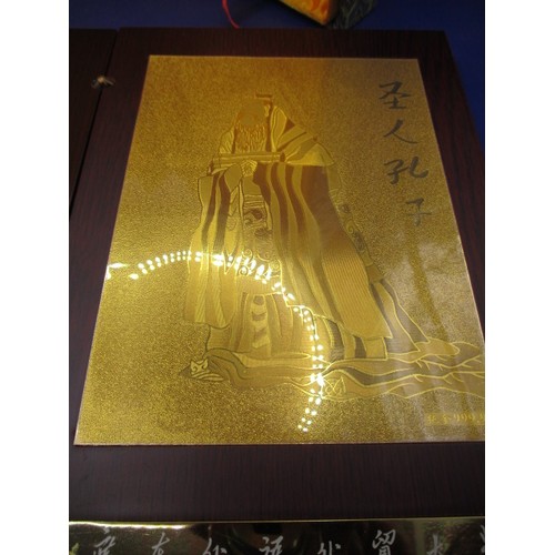 174 - A boxed, wood covered booklet on with a story of Confucius having gold panel marked 999.9, in use co... 