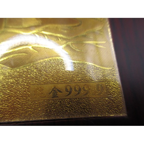 174 - A boxed, wood covered booklet on with a story of Confucius having gold panel marked 999.9, in use co... 