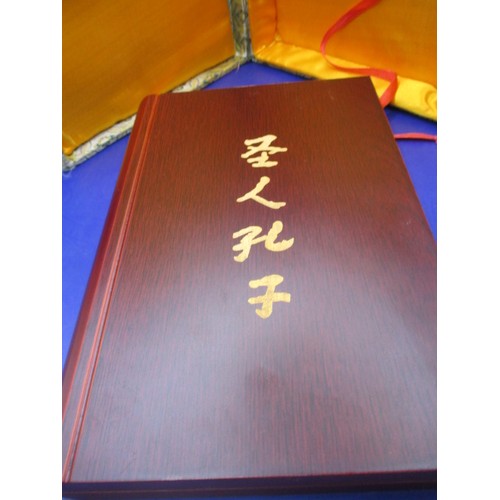 174 - A boxed, wood covered booklet on with a story of Confucius having gold panel marked 999.9, in use co... 