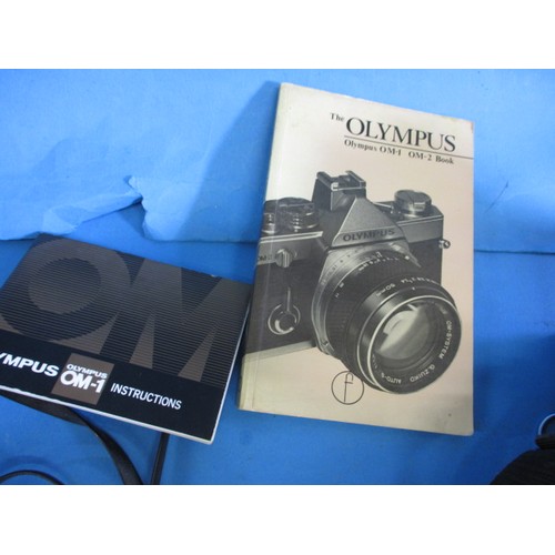 286 - An Olympus OM1n roll film camera, with additional lenses, in carry case with booklets, in working or... 