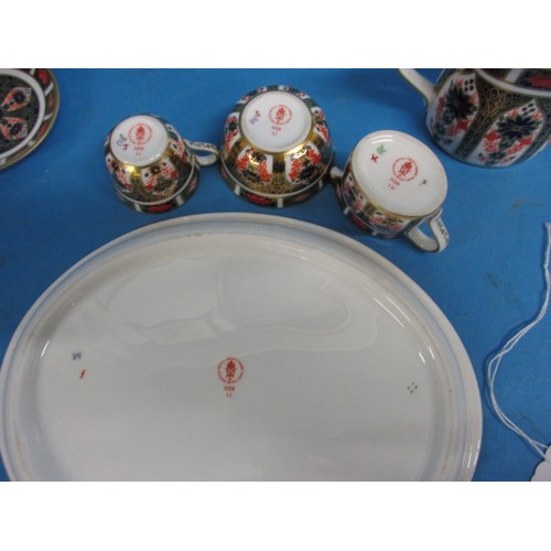 182 - A Royal Crown Derby miniature tea set on tray, in the 1128 pattern, all with same date numbers, in u... 