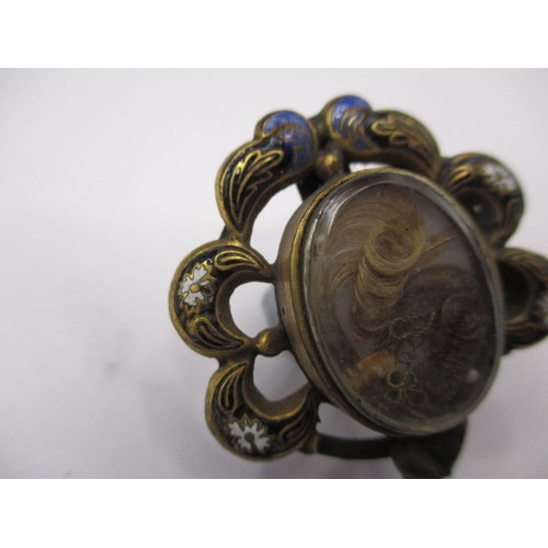 83 - A 19th century mourning brooch with hair panel and enamel decoration, some trim missing to edge