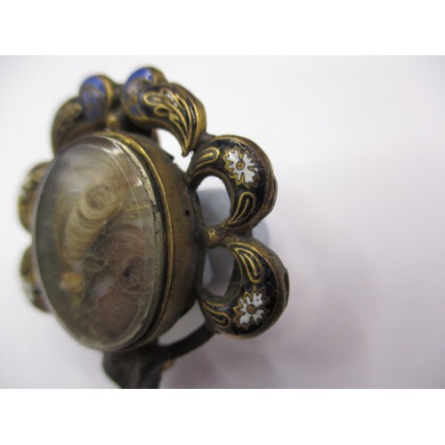 83 - A 19th century mourning brooch with hair panel and enamel decoration, some trim missing to edge