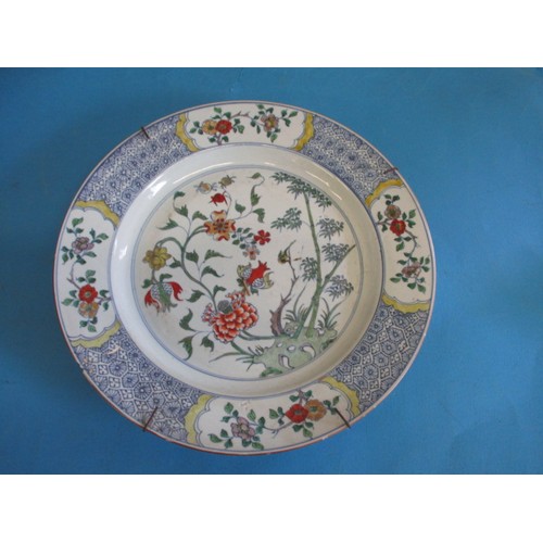 173 - An antique oriental wall plate with polychrome floral decoration front and back, approx. diameter 36... 