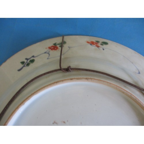 173 - An antique oriental wall plate with polychrome floral decoration front and back, approx. diameter 36... 