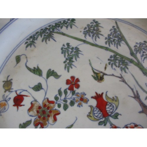 173 - An antique oriental wall plate with polychrome floral decoration front and back, approx. diameter 36... 