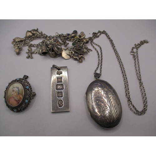 84 - A parcel of silver and white metal jewellery items, to include a charm bracelet and ingot pendant, a... 