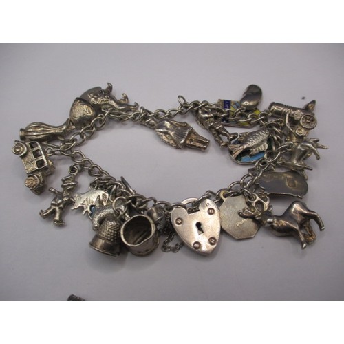 84 - A parcel of silver and white metal jewellery items, to include a charm bracelet and ingot pendant, a... 