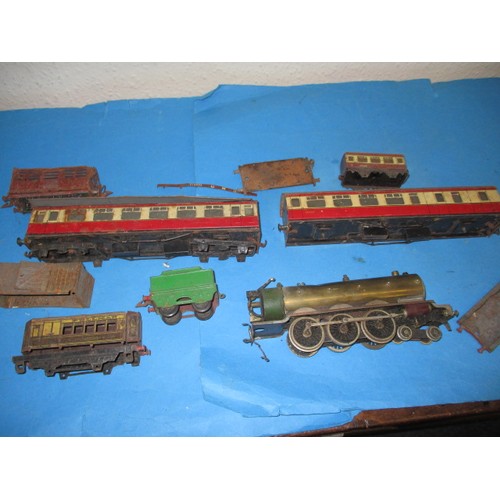 A parcel of vintage ‘O’ gauge model railway items to include a part built live steam loco, and some tin plate rolling stock by Bing, all in well used condition and in need of repairs