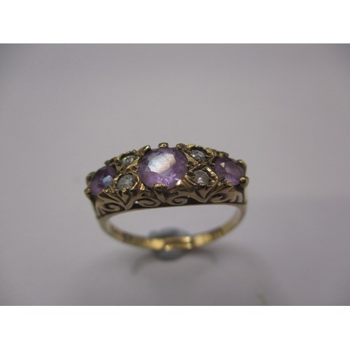 29 - A 9ct yellow gold dress ring with 3 amethysts and 4 white stones, approx. ring size ‘M’, approx. wei... 