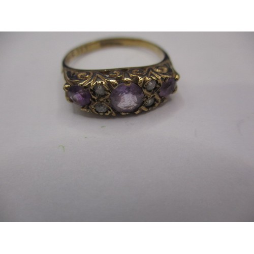 29 - A 9ct yellow gold dress ring with 3 amethysts and 4 white stones, approx. ring size ‘M’, approx. wei... 