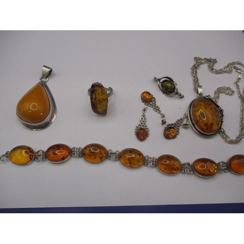 85 - A large butterscotch natural amber tear shaped pendant in white metal mount and a quantity of other ... 