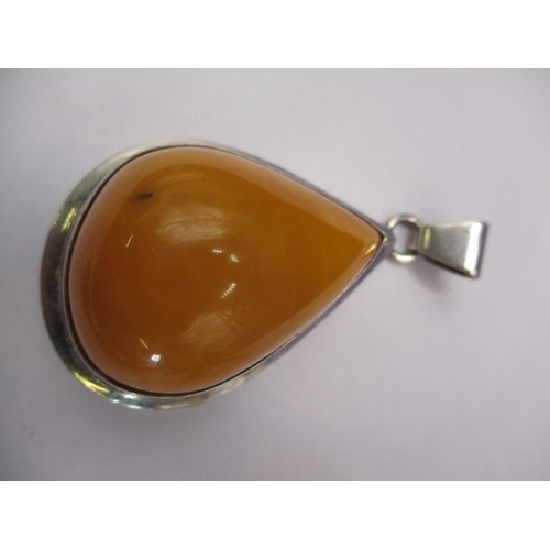 85 - A large butterscotch natural amber tear shaped pendant in white metal mount and a quantity of other ... 