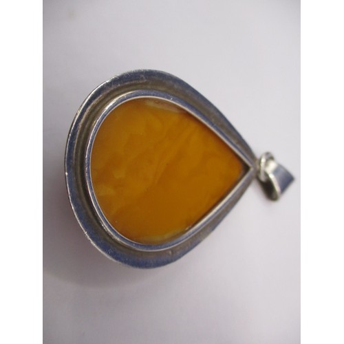 85 - A large butterscotch natural amber tear shaped pendant in white metal mount and a quantity of other ... 