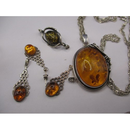 85 - A large butterscotch natural amber tear shaped pendant in white metal mount and a quantity of other ... 