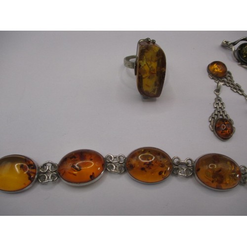 85 - A large butterscotch natural amber tear shaped pendant in white metal mount and a quantity of other ... 